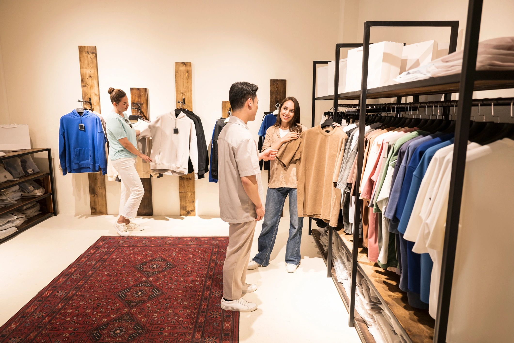 Customers exploring fashion products in a modern boutique retail setting